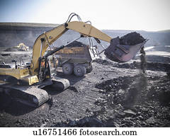 Digger scooping coal at mine