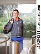 Man walking through turnstile