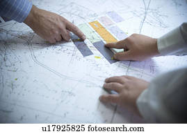 Business people reading coal mine plans