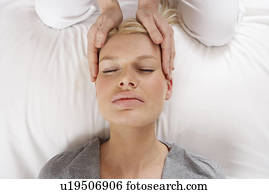 Woman having Shiatsu massage to head