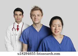 Portrait of diverse medical team standing over gray background