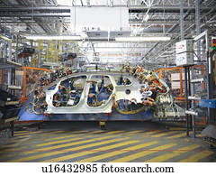 Car body part in welding jig in car factory