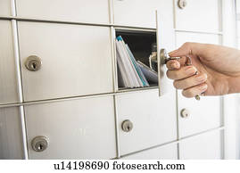 Woman closing safety deposit box