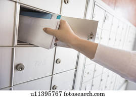 Woman taking letters from safety deposit box