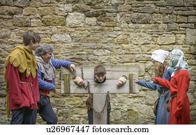 Students examining medieval stocks