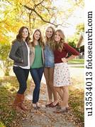 Full length portrait of four friends