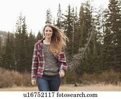 Portrait of young woman walking in non-urban scene