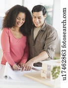 Smiling couple with model home