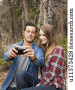 Young couple self photographing in non-urban scene