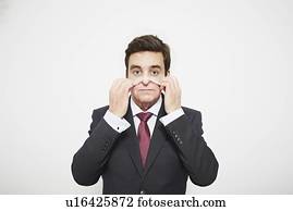 Businessman pulling on mask