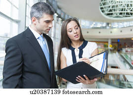 Businessman and woman discussing work