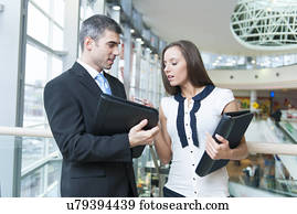 Businessman and woman discussing work