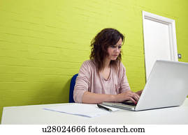 Close-up view of Young woman working at her desk