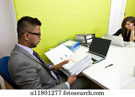 Colleagues working at their desks