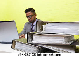 Portrait of Indian Businessman working on his laptop computer at his desk