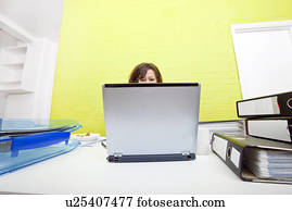 Womans head poking out over top of laptop