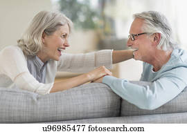 Senior couple sitting on sofa