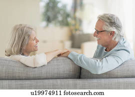 Senior couple sitting on sofa