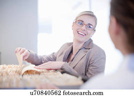 Receptionist looking through hospital index cards