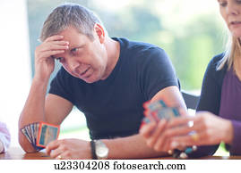 Mature male playing cards with family