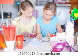 Two young sisters checking stall profits