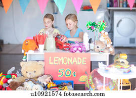 Two young sisters setting up stall