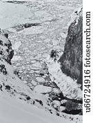 Monochrome aerial view of floating sea ice in a channel : deep gully with steep cliffs either side in the snow, Shiretoko National Park, Hokkaido, Japan