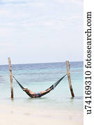 Grandfather And Grandson Relaxing In Beach Hammock 