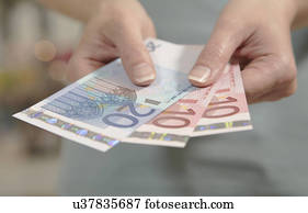 Female hands holding ten and twenty euro notes
