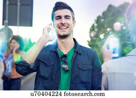 Three young adults using illuminated smartphones