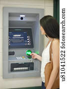 Young woman withdrawing money at cash machine