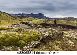 Boy gazing over volcanic landscape, Nesjavellir, Iceland