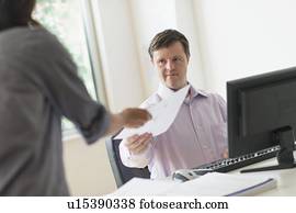 Man with down syndrome working in office