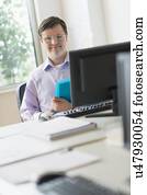 Man with down syndrome working in office