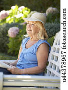 Senior woman reading in garden