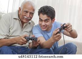 Grandfather and grandson playing video game