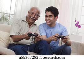 Grandfather and grandson playing video game
