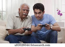 Grandfather and grandson playing video game