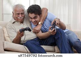 Grandfather and grandson playing video game
