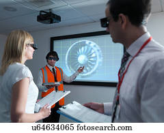 Engineers and apprentice in 3D glasses with clipboards in front of  engine on 3D screen