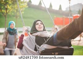 Young Woman On Beach Swinging On Playground Swing Stock