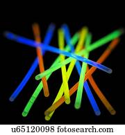 Glow sticks against a black background.