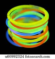 Glowstick bangles against a black background.