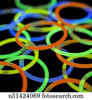 Glowstick bangles against a black background.