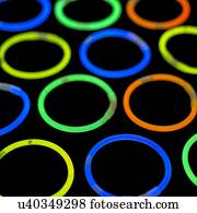 Glowstick bangles against a black background.