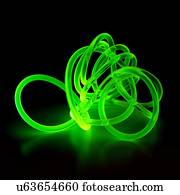 Green coloured glowing cable against a black background.