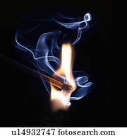 Matchstick on fire against a black background.