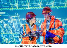 Engineers with digital tablet and projected plans