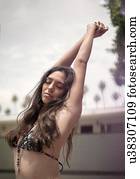 Young woman in bikini enjoying fresh air