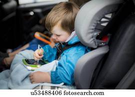 Boy in car using digital device